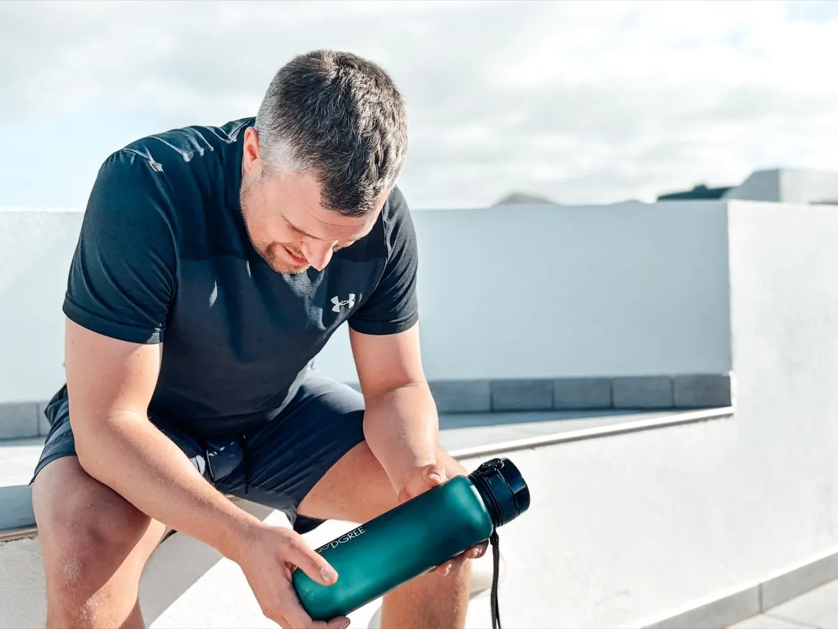 Athlete taking a water break outside