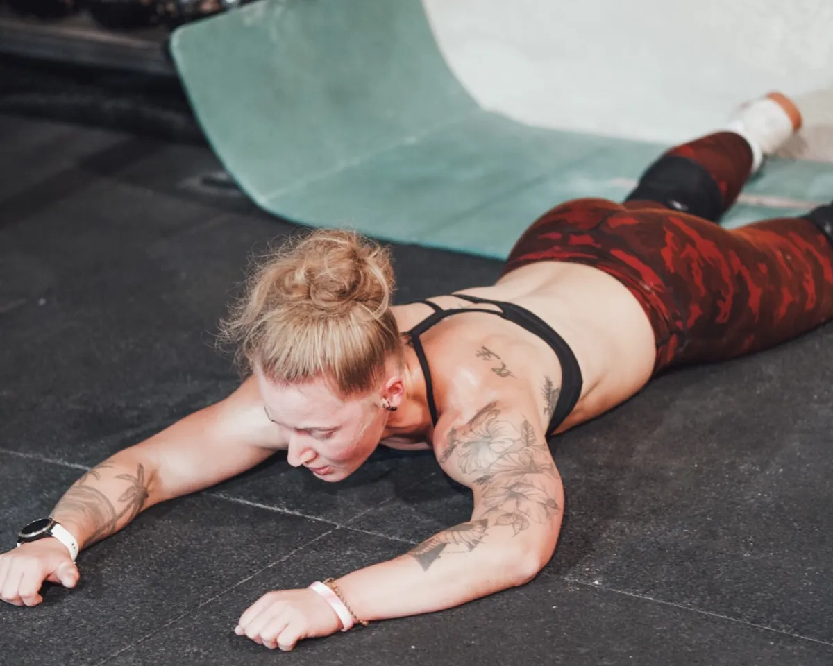 Exhausted athlete lying on the floor after training