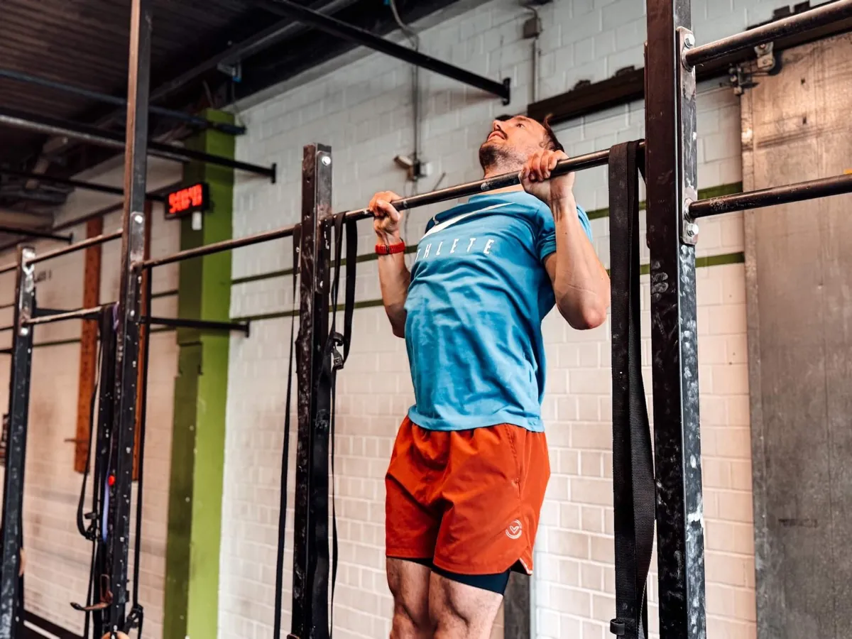 Athlete doing pull-ups on the rig in a CrossFit box