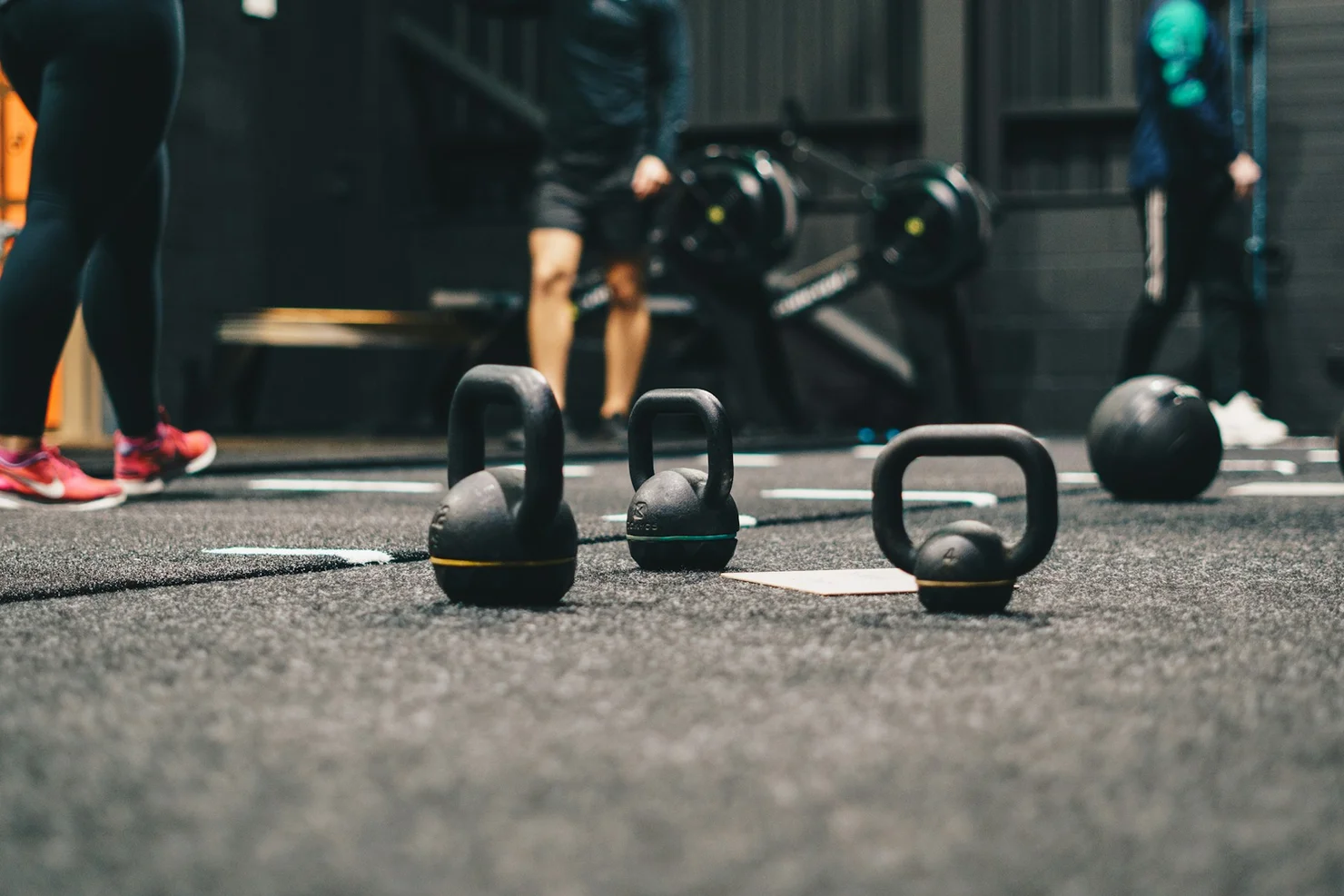 Various kettlebells standing on the floor