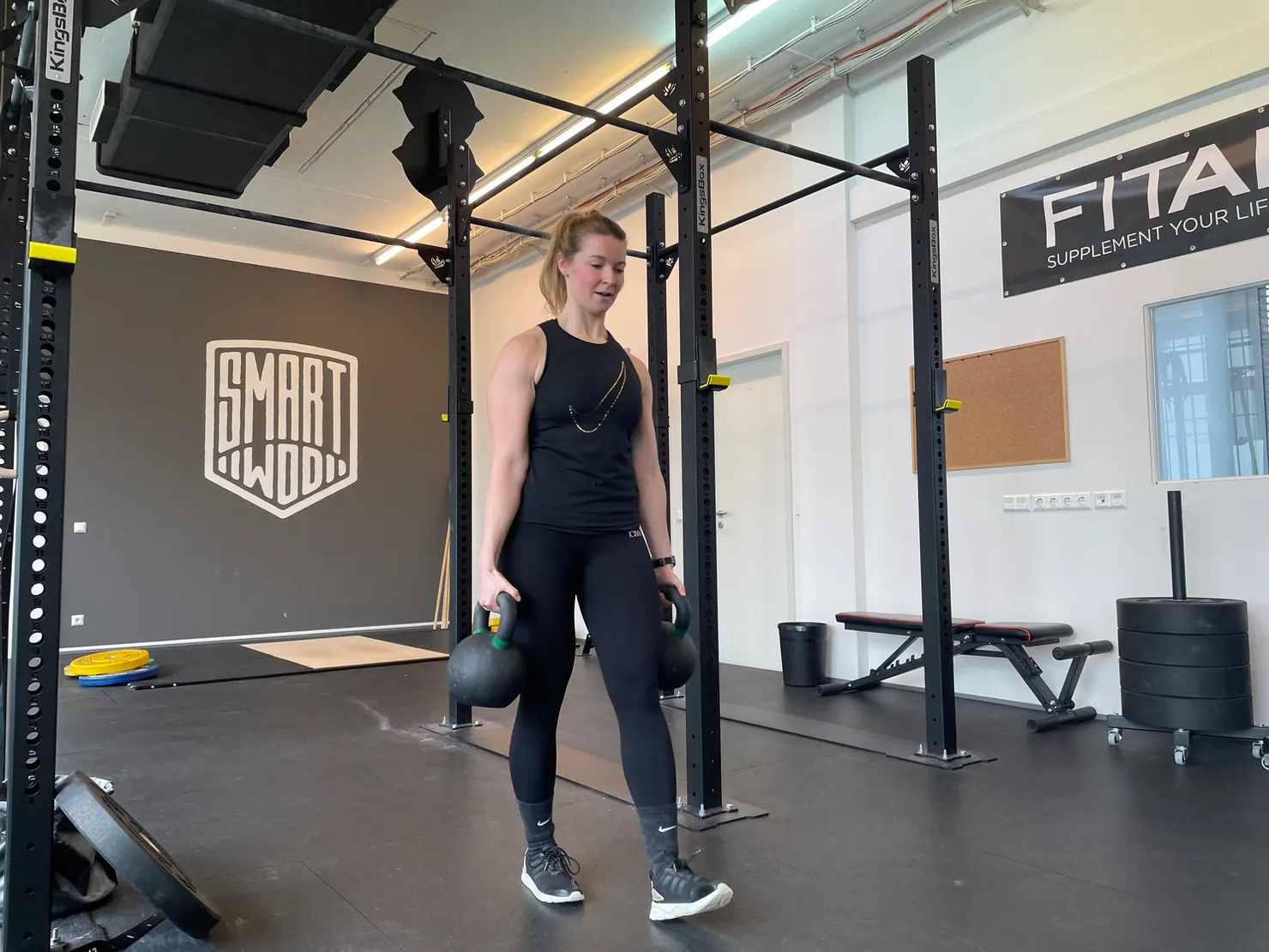Woman carrying two kettlebells